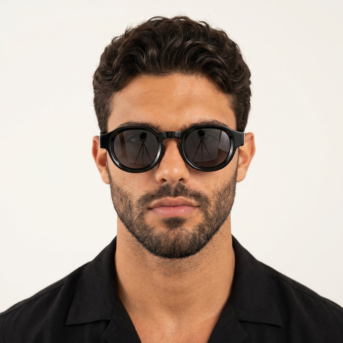 A man wearing nadaraty eyewear Horus Pro H 178 black acetate sunglasses with a bold rounded frame design.