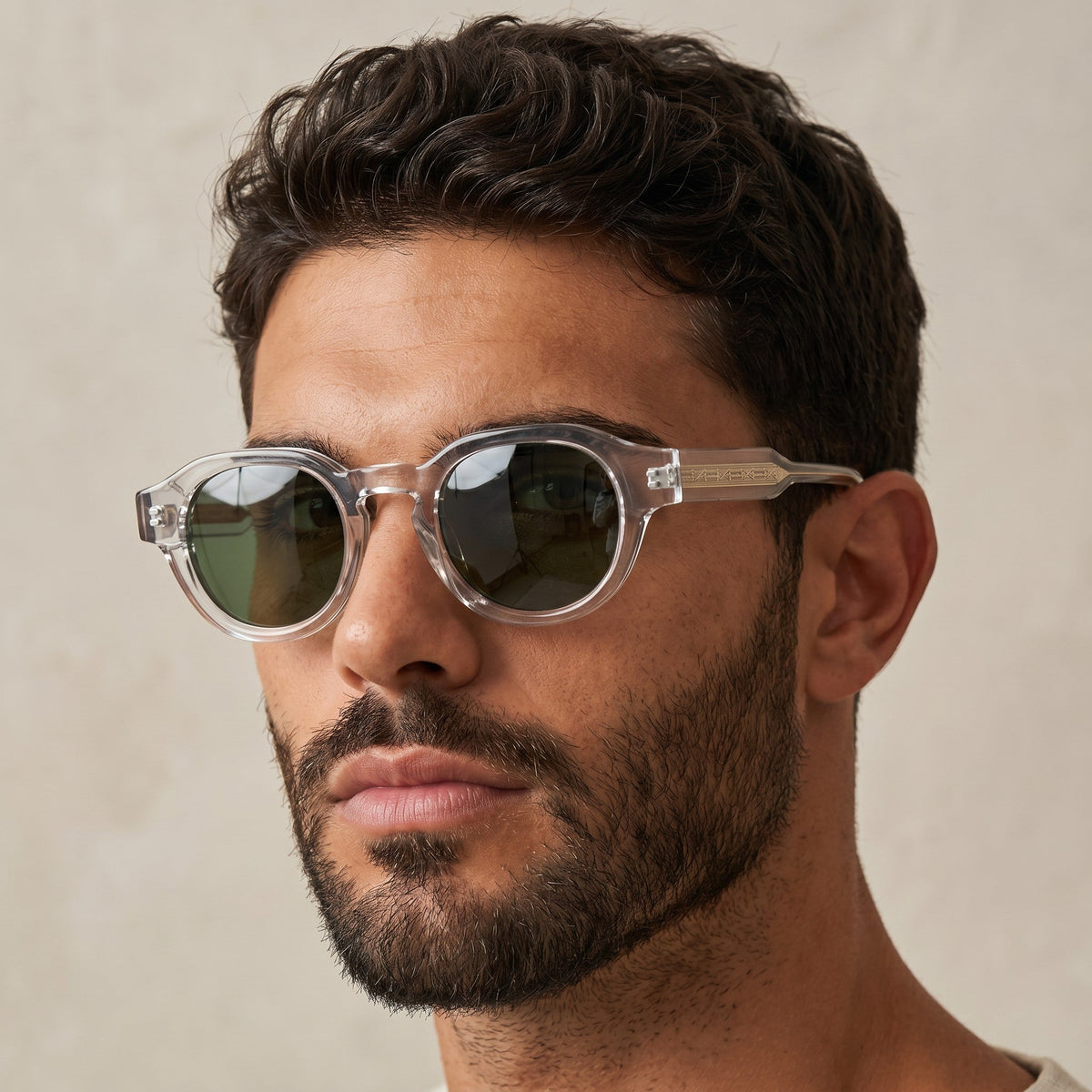 Man wearing nadaraty eyewear Horus Pro H 178 sunglasses with clear acetate frames and dark green lenses